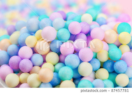 Foam beads of various colors brightly colored background. 87457781