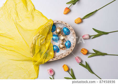 Happy easter time. Bright Easter holiday concept with spring flowers and easter eggs. Colorful Easter eggs background 87458936