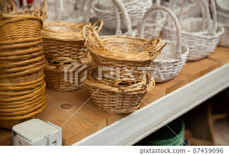 Wicker baskets on shelves in store Wicker baskets on shelves in store 87459096