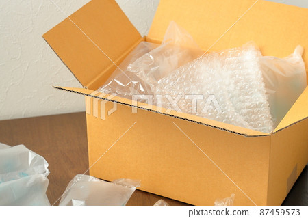 Cardboard boxes and cushioning materials placed on the floor Cardboard boxes and cushioning materials placed on the floor 87459573