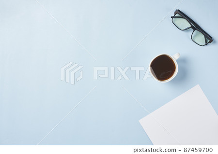 Bright office workspace. Work space with notepad, keyboard, coffee and glasses. Work space table desk. Flat lay, top view, copy space Bright office workspace. Work space with notepad, keyboard, coffee and glasses. Work space table desk. Flat lay, top view, copy space 87459700
