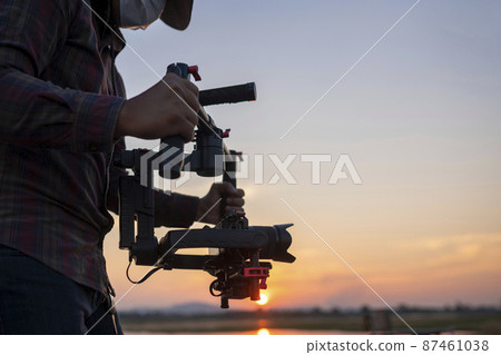 Filmmaker or content creator using stabilizer gimbal camera take video footage on the location outdoor Filmmaker or content creator using stabilizer gimbal camera take video footage on the location outdoor 87461038