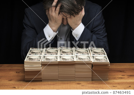 A man holding a large wad of bills and a head 87463491