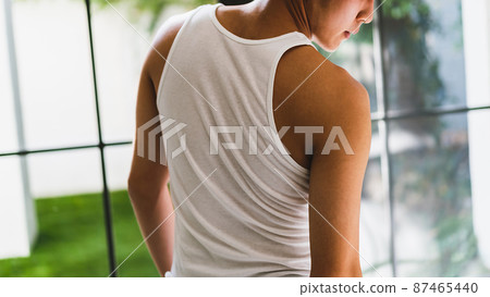 Man in white tank top 87465440