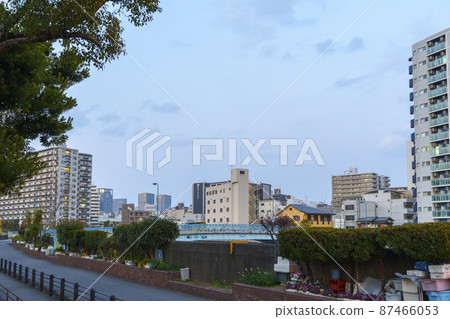 Osaka cityscape near Matsushima Bridge, Nishi-ku, Osaka City seen from Hakuraku Bridge Evening view 87466053