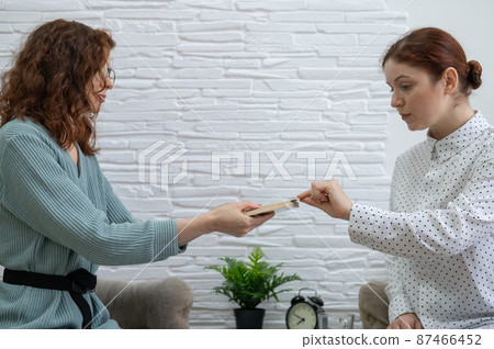 Psychologist uses metaphorical associative cards in a session with a patient. 87466452