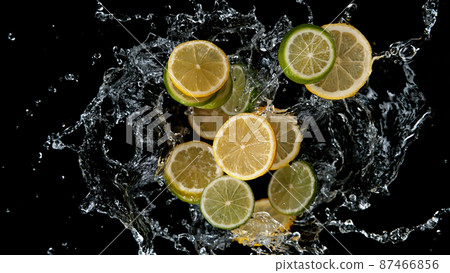 Freeze motion of sliced limes and lemons in water splash. 87466856