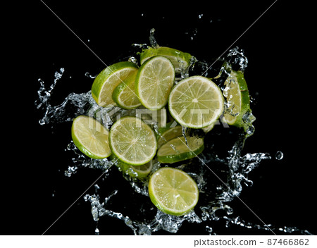 Freeze motion of sliced limes in water splash. 87466862