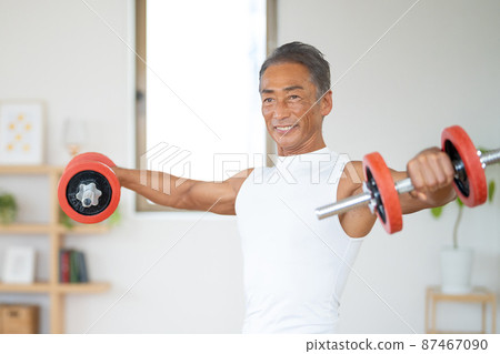 Senior male bodybuilder doing muscle training 87467090