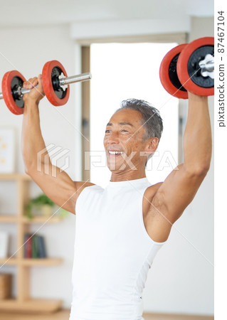 Senior male bodybuilder doing muscle training 87467104