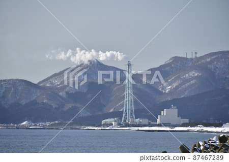 Taking a picture of the chimney of the Chimney power plant in Shiriuchi-cho, Hokkaido in early spring Taking a picture of the chimney of the Chimney power plant in Shiriuchi-cho, Hokkaido in early spring 87467289