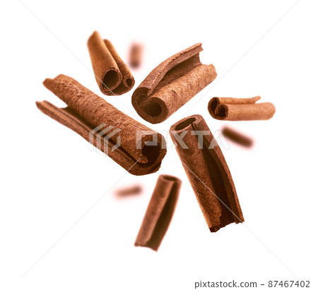 Cinnamon sticks levitate on a white background 87467402