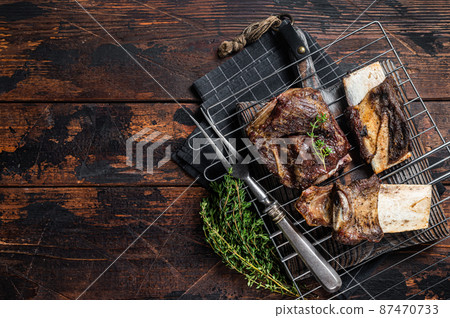 Barbecue chuck beef short ribs on grill. Wooden background. Top view. Copy space 87470733