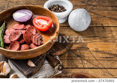 Turkish breakfast with Fried sausage sucuk on a rustic plate. Wooden background. Top view. Copy space Turkish breakfast with Fried sausage sucuk on a rustic plate. Wooden background. Top view. Copy space 87470868