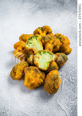 Fried Crumbed broccoli on kitchen table. White background. Top view 87470901