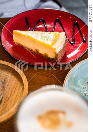 Classic New York strawberries and lemon Cheesecake on a wooden table in cafe. Top view Classic New York strawberries and lemon Cheesecake on a wooden table in cafe. Top view 87471153
