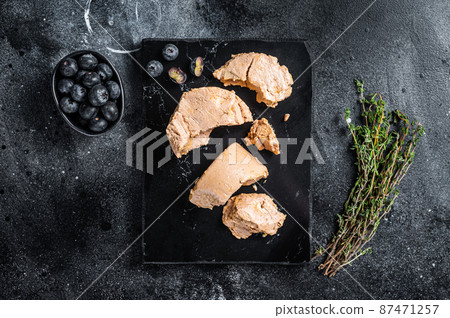 Foie gras duck liver pate and fresh blueberry. Black background. Top view 87471257