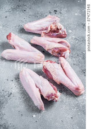 Fresh raw duck wings on kitchen table. Gray background. Top view Fresh raw duck wings on kitchen table. Gray background. Top view 87471548