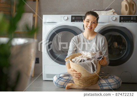 woman is doing laundry woman is doing laundry 87472232