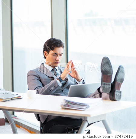 The young successful businessman working at the office 87472419
