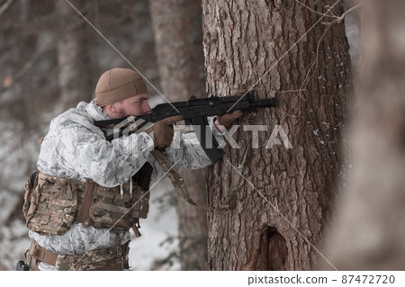 Soldier in winter camouflaged uniform in Modern warfare army on a snow day on forest battlefield with a rifle. Model face very similar to Ukraine prime minister. Soldier in winter camouflaged uniform in Modern warfare army on a snow day on forest battlefield with a rifle. Model face very similar to Ukraine prime minister. 87472720
