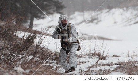 Soldier in winter camouflaged uniform in Modern warfare army on a snow day on forest battlefield with a rifle. Model face very similar to Ukraine prime minister. Soldier in winter camouflaged uniform in Modern warfare army on a snow day on forest battlefield with a rifle. Model face very similar to Ukraine prime minister. 87472745