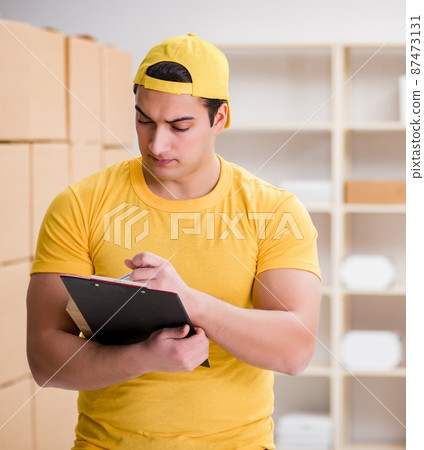 Man working in postal parcel delivery service office Man working in postal parcel delivery service office 87473131