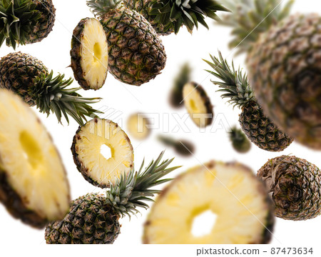Ripe pineapples levitate on a white background 87473634
