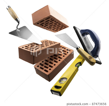 Bricks and construction tools levitate on a white background Bricks and construction tools levitate on a white background 87473656