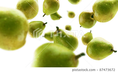 Green pears levitate on a white background 87473672