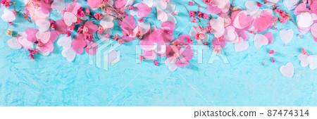 Valentine day or wedding panorama with pink hearts and flowers confetti Valentine day or wedding panorama with pink hearts and flowers confetti 87474314