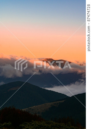 Petros Mountain in the morning fog, overcast mountain range at dawn, the magical mountains of Ukraine. Petros Mountain in the morning fog, overcast mountain range at dawn, the magical mountains of Ukraine. 87474728