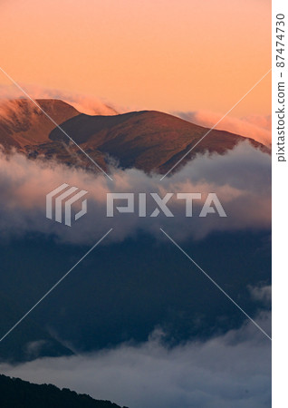 Dawn in the mountains, clouds covered the slopes of the Carpathians. Dawn in the mountains, clouds covered the slopes of the Carpathians. 87474730