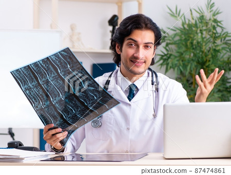 The young handsome doctor radiologist working in the clinic The young handsome doctor radiologist working in the clinic 87474861