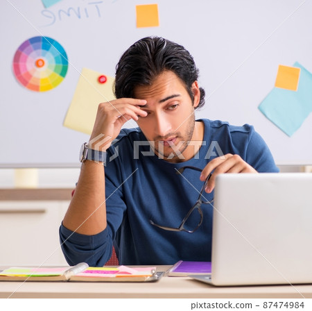 The young handsome designer working at the project The young handsome designer working at the project 87474984