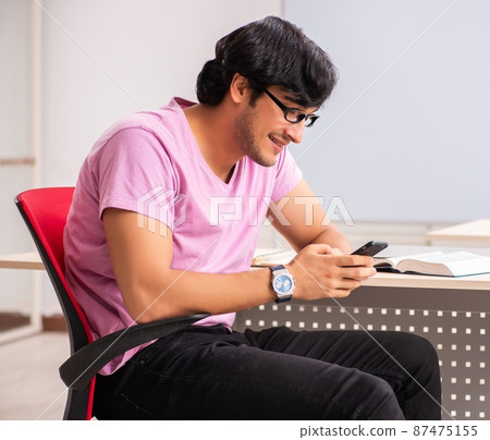 The young male student sitting in the class 87475155