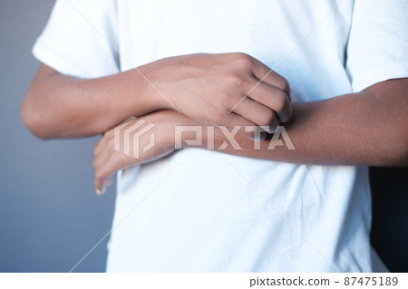 man suffering from itching skin, close up. man suffering from itching skin, close up. 87475189