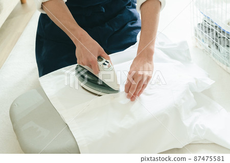 Young man ironing 87475581