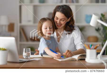 Girl doing homework or online education. Girl doing homework or online education. 87476660