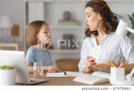 Girl doing homework or online education. Girl doing homework or online education. 87476661