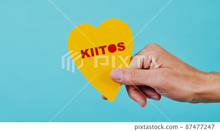 man shows heart with the text thank you in finnish 87477247