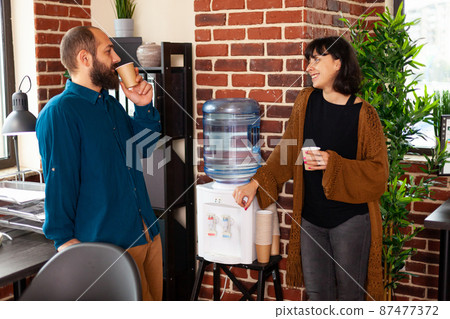 Businessman taking work break talking with executive manager collaborating and communicating 87477372