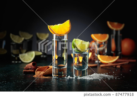 Tequila shots on a black background. 87477918