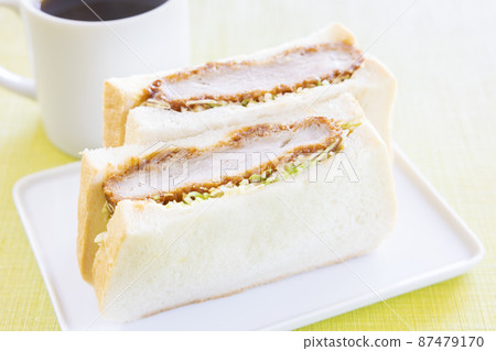 Delicious cutlet sandwich and hot coffee 87479170