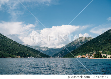 Ships sailing on the sea against the background of mountains Ships sailing on the sea against the background of mountains 87479367