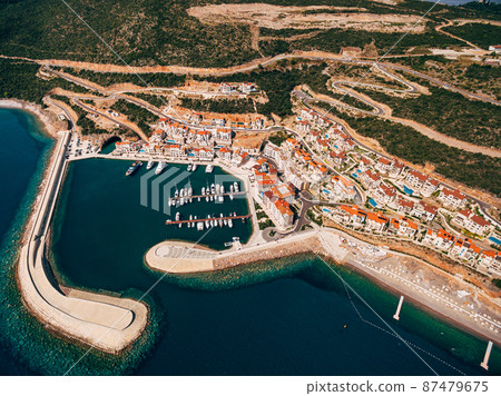 Aerial view of Lustica Bay residential complex with pier and yachts. Montenegro Aerial view of Lustica Bay residential complex with pier and yachts. Montenegro 87479675
