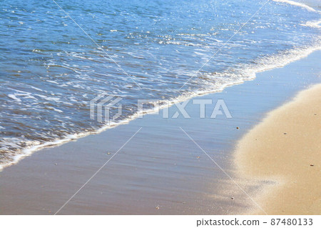 Ripples crashing on the beach 87480133