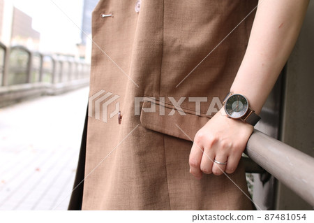 A woman's arm with a wedding ring and a wristwatch A woman's arm with a wedding ring and a wristwatch 87481054