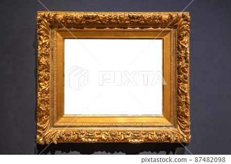 Antique golden carved picture frame on wall 87482098