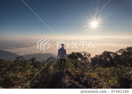 Man traveler standing on top of mountain in wildlife sanctuary 87482100